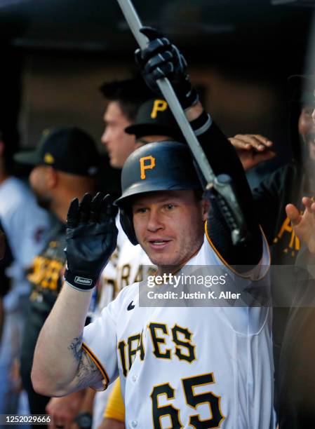 Jack Suwinski of the Pittsburgh Pirates celebrates in the dugout after hitting a solo home run in the first inning against the Cincinnati Reds at PNC...