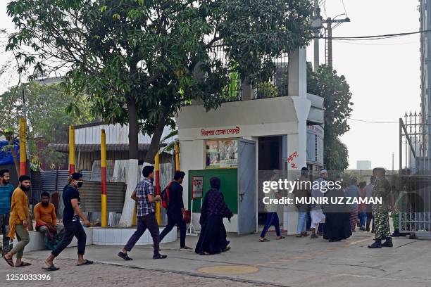 In this photograph taken on April 13 workers enter a garment factory in Savar, on the outskirts of Dhaka. The tenth anniversary of the Rana Plaza...