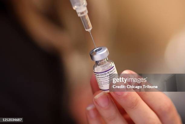 Roseland Community Hospital nurse prepares doses of the Pfizer vaccine on Dec. 30 during a COVID-19 vaccination event at Josephine&apos;s Southern...