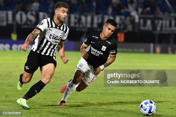 Libertad's forward Hector Villalba and Alianza Lima's defender Ricardo Lagos vie for the ball during the Copa Libertadores group stage first leg...