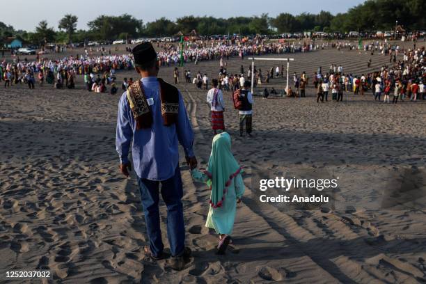 Muslims walk as they attend the Eid Al-Fitr prayer on the 'sea of sands' at Parangkusumo beach on April 21, 2023 in Yogyakarta, Indonesia. Indonesia,...