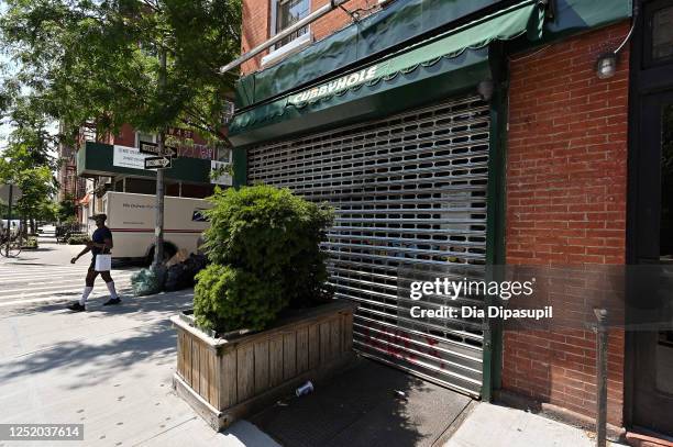 Man walks past a temporarily closed Cubbyhole in the West Village on June 23, 2020 in New York City. Pride Week in New York City usually brings an...