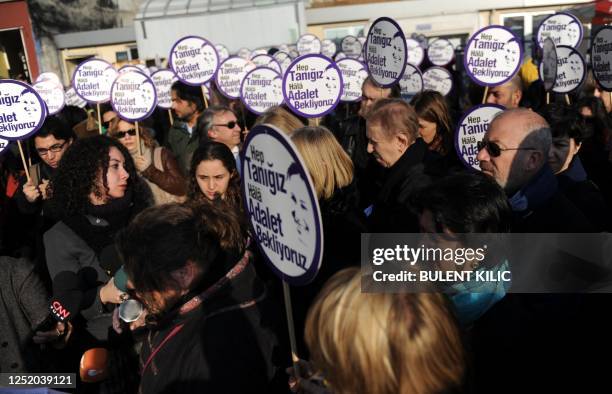 Turkish sociologist Pinar Selek's supporters hold signs, reading: ''We are all witnesses. We are still waiting for justice,'' during a demonstration...