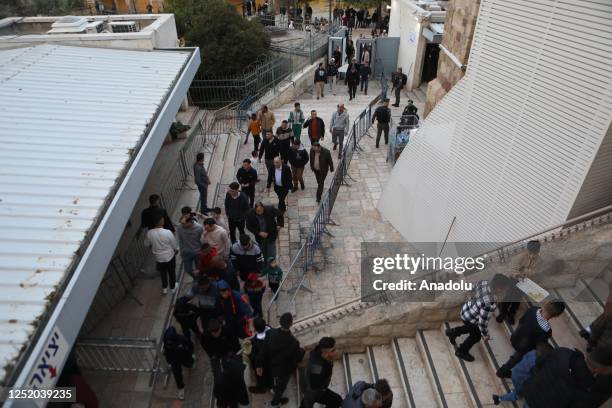 Muslims pass the checkpoint to perform the Eid al-Fitr prayer during the first day of the Eid al-Fitr holiday at Ibrahimi Mosque in Hebron, West Bank...