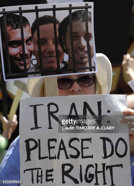 Demonstrator holds a postersw during a protest outside the Iran Mission in New York on July 30, 2010 in support of Josh Fattal, Shane Bauer and Sarah...