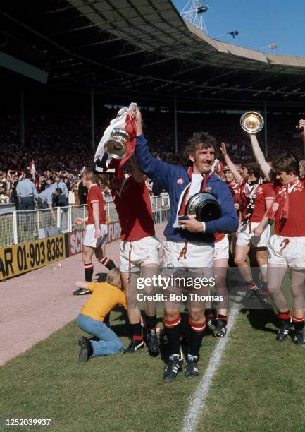 Manchester United goalkeeper Alex Stepney celebrates with the trophy after the FA Cup final between Liverpool and Manchester United at Wembley...