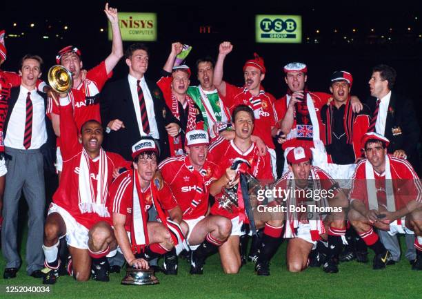 Manchester United line up for a group photo as they celebrate with the trophy after winning the FA Cup final replay between Crystal Palace and...