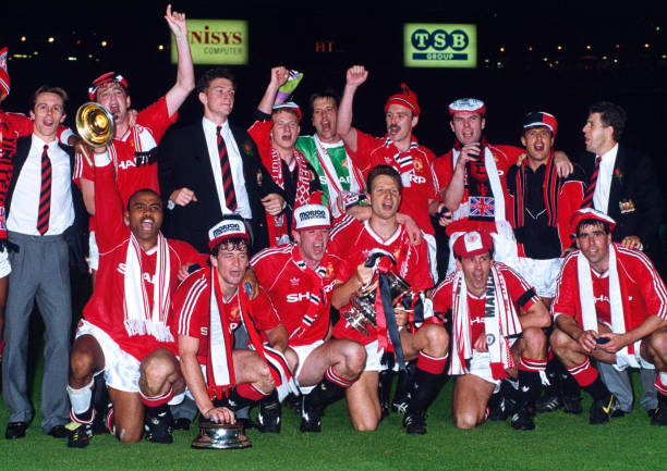 Manchester United line up for a group photo as they celebrate with the trophy after winning the FA Cup final replay between Crystal Palace and...