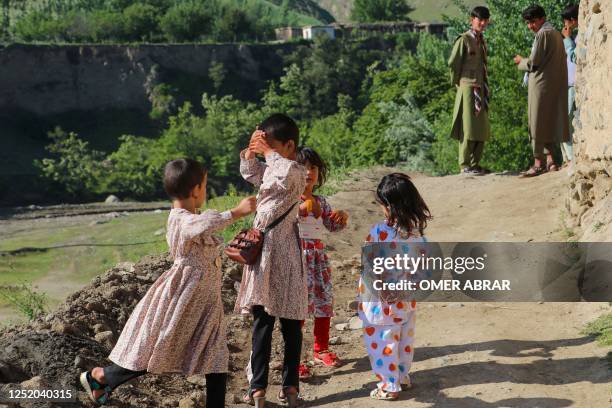 Afghan girls wear new dress to celebrate Eid al-Fitr, which marks the end of the holy fasting month of Ramadan, in Fayzabad district of Badakhshan...