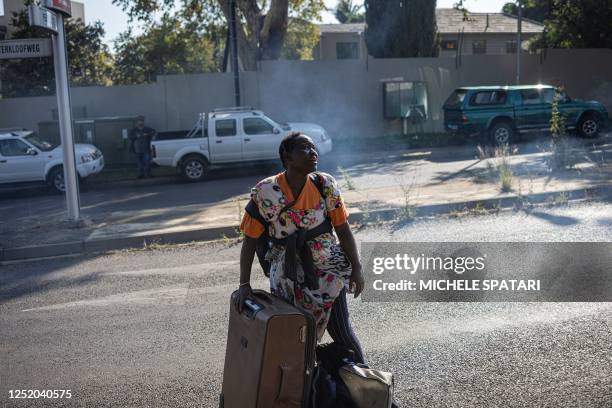 Foreign migrant screams in anger while she is evicted from a temporary dwelling built in front of the United Nations High Commissioner for Refugees...