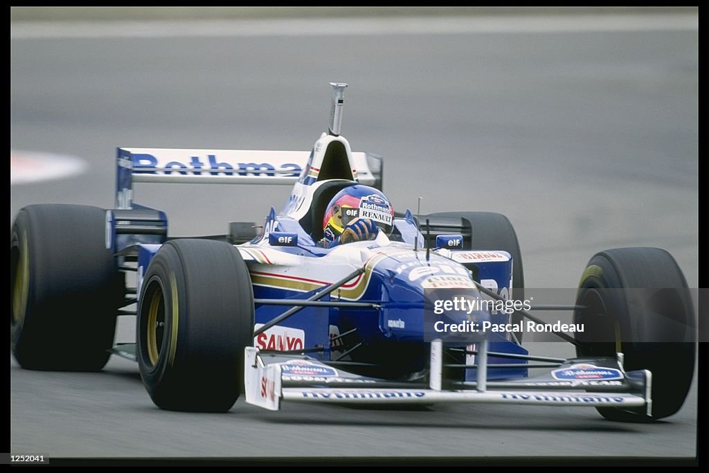 Jacque Villeneuve of Canada and the Williams Renault Team closes in on Damon Hill