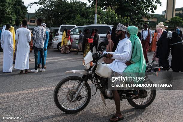 Muslim worshippers arrive to attend a prayer on the first day of Eid al-Fitr, which marks the end of the holy fasting month of Ramadan, at Kadafi...