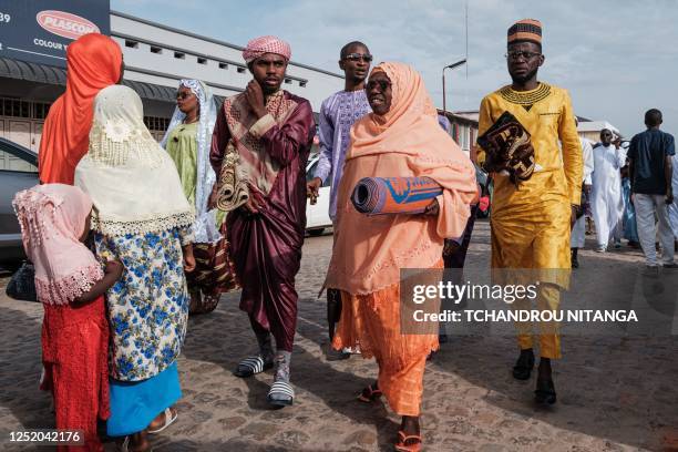 Muslim worshippers arrive to attend a prayer on the first day of Eid al-Fitr, which marks the end of the holy fasting month of Ramadan, at Kadafi...