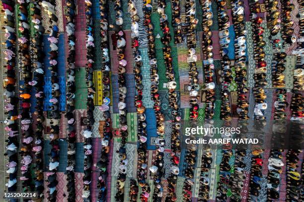 In this aerial view Muslim worshippers pray on the first day of Eid al-Fitr, which marks the end of the holy fasting month of Ramadan, in Syria's...