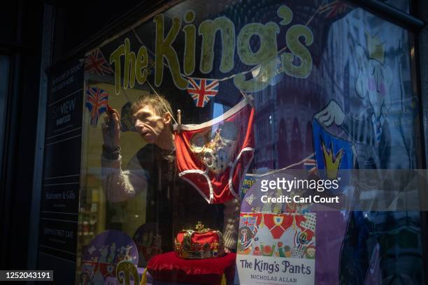 Nicholas Allan, illustrator and author of The King's Pants, draws a picture in the window of Waterstones bookshop as part of the store's promotion...