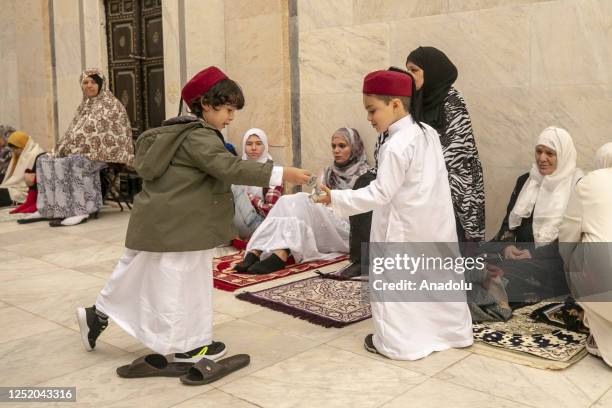 Children play as Muslims gathering to perform the Eid al-Fitr prayer during the first day of the Eid al-Fitr holiday at Saheb Ettabaa Mosque in...