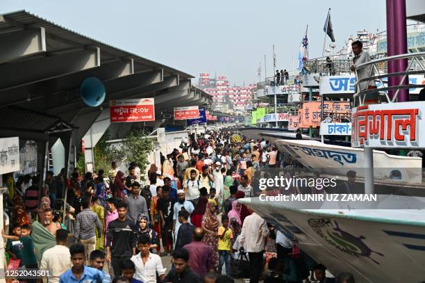 People gather at a ferry terminal to board ferries in Dhaka on April 21 as they travel back home ahead of Eid al-Fitr festival marking the end of the...