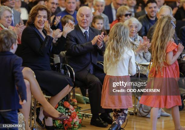 Argentine-born pianist and conductor Daniel Barenboim and his wife Russian-born pianist Elena Bashkirova applaud to a children's choir after...