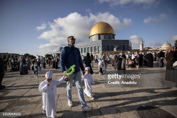 Muslims celebrate the Eid al-Fitr in the courtyard after performing the Eid al-Fitr prayer at Masjid al-Aqsa Compound in East Jerusalem on April 21,...