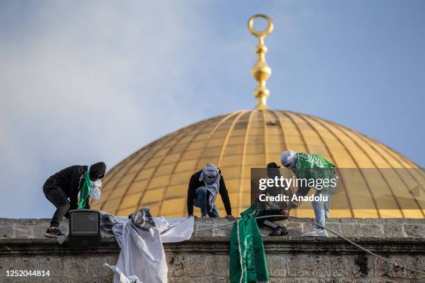 Group of muslims organize a show of support for al-Aqsa after performing the Eid al-Fitr prayer in front of the Qubbat al-Sakhra at Masjid al-Aqsa...