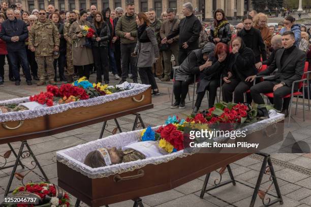 Relatives, friends, and others mourn over the coffins of a former member of Ukraine's parliament and soldier Oleh Barna, and Ukrainian serviceman...