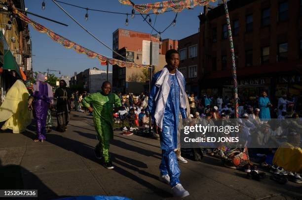 Members of the Muslim community attend prayers outside the Masjid At Taqwa during Eid al-Fitr celebrations in the Brooklyn borough of New York City...