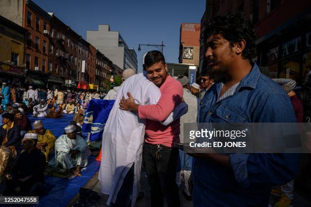 Members of the Muslim community attend prayers outside the Masjid At Taqwa mosque during Eid al-Fitr celebrations in the Brooklyn borough of New York...