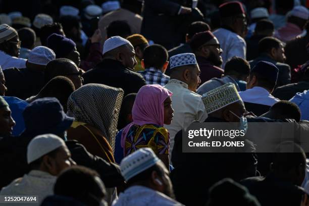 Members of the Muslim community attend prayers outside the Masjid At Taqwa during Eid al-Fitr celebrations in the Brooklyn borough of New York City...