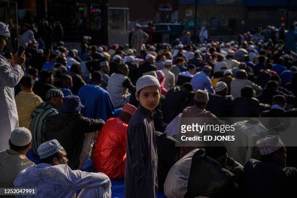 Members of the Muslim community attend prayers outside the Masjid At Taqwa during Eid al-Fitr celebrations in the Brooklyn borough of New York City...