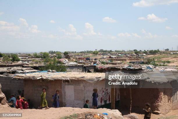 Afghan refugee children, living with their families at a refugee camp, are seen during the first day of the Eid al-Fitr in Islamabad, Pakistan on...