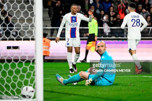 Paris Saint-Germain's French forward Kylian Mbappe celebrates after scoring his team's first goal during the French L1 football match between SCO...