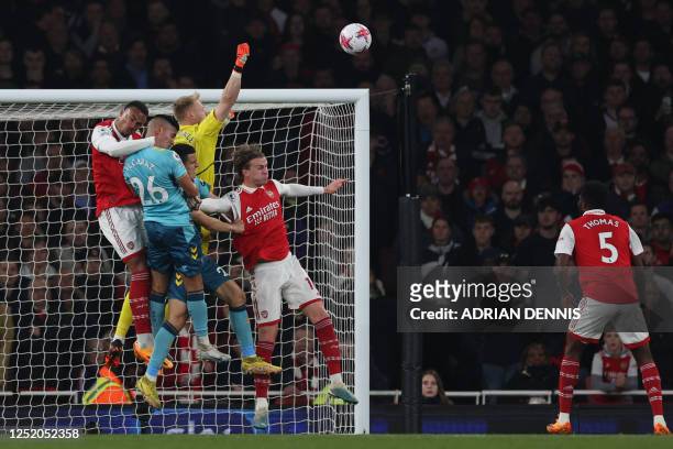 Arsenal's English goalkeeper Aaron Ramsdale punches the ball clear after a corner kick during the English Premier League football match between...