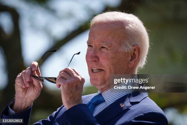 President Joe Biden puts on his sunglasses as he speaks before signing an executive order that would create the White House Office of Environmental...