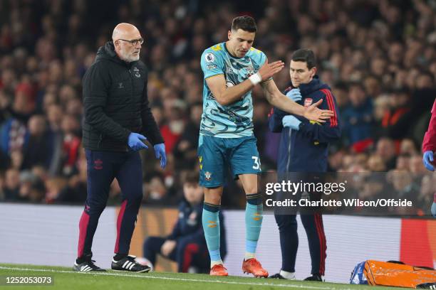 Jan Bednarek of Southampton complains as he is forced off with an injury during the Premier League match between Arsenal FC and Southampton FC at...