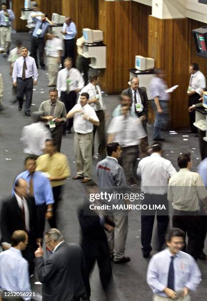 Operators at the Brazilian stock market negotiate trades 16 December 2002 in Sao Paulo, Brazil. The Brazilian currency opened at 3.63 reals to the US...