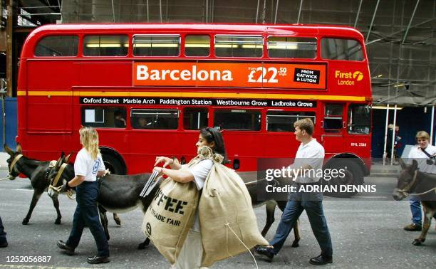 Oxfam campaigners walk donkeys through a London street to protest against unfair practices of giant multinational coffee companies 18 September 2002....