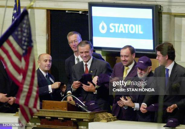 Inge K. Hansen, chief financial officer of Statoil ASA of Norway , prepares to throw a Statoil hat on to the trading floor after ringing the opening...