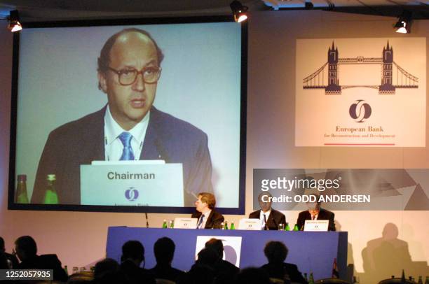 French finance minister and European bank for reconstruction and development chairman Laurent Fabius is projected on a video screen as he addresses...