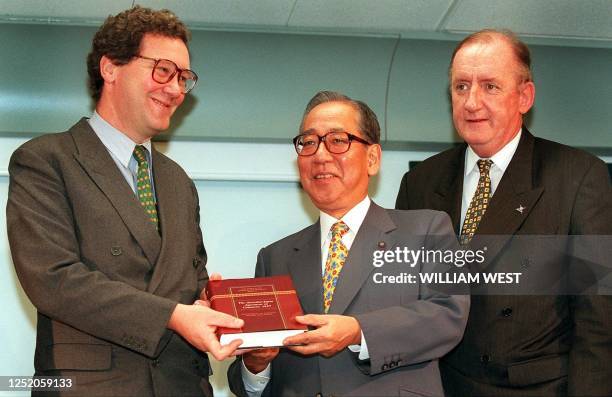 Australian Foreign Affairs Minister Alexander Downer with Japan's Minister for International Trade and Industry Shinji Sato and Australia's Deputy...