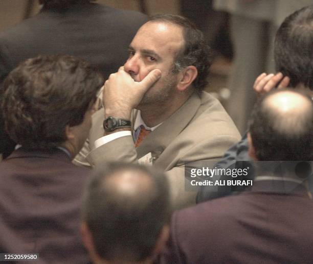 Trader is seen biting a ticket in Buenos Aires, Argentina 17 January 2002. Un operador de la Bolsa de Valores de Buenos Aires permanece expectante...