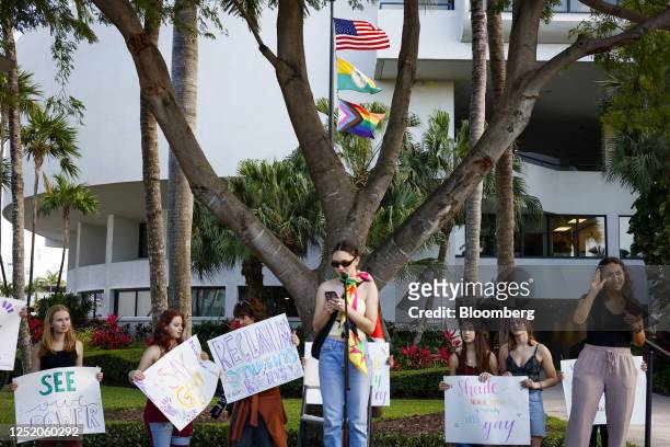 Demonstrators hold placards during a 'Walkout 2 Learn' rally in Miami, Florida, US, on Friday, April 21, 2023. The youth-led statewide walkout comes...
