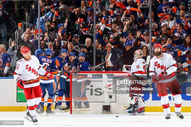 Casey Cizikas of the New York Islanders is congratulated by his teammates after scoring a goal as the Carolina Hurricanes react during the second...