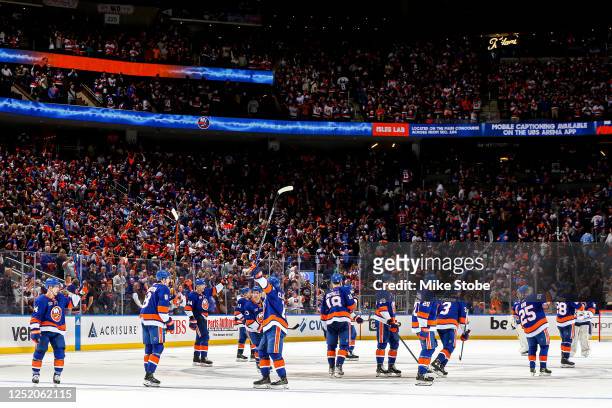 The New York Islanders celebrate their 5-1 win against the Carolina Hurricanes in Game Three of the First Round of the 2023 Stanley Cup Playoffs at...