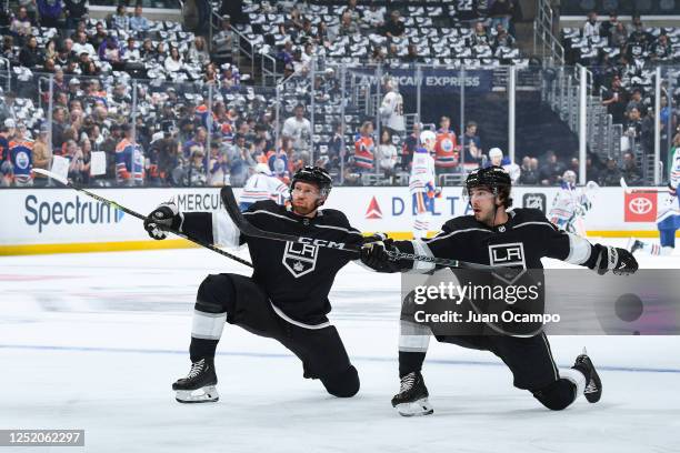 Vladislav Gavrikov of the Los Angeles Kings and Sean Durzi stretch during warm ups prior to the game against the Edmonton Oilers in Game Three of the...