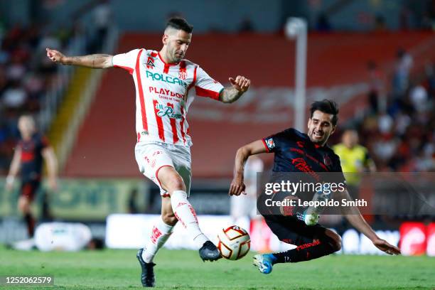 Edgar Mendez of Necaxa competes for the ball with Gaddi Aguirre of Atlas during the 16th round match between Necaxa and Atlas as part of the Torneo...