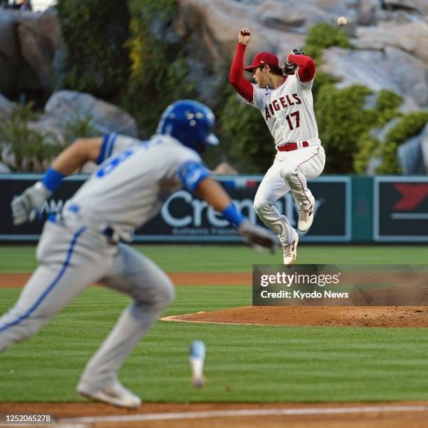 Los Angeles Angels two-way player Shohei Ohtani reacts to a grounder from Nicky Lopez of the Kansas City Royals in the third inning of a baseball...