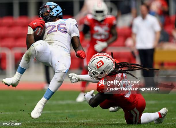 Arlington's Leddie Brown, left, is upended by Defenders safety D.J. Swearinger during the DC Defenders defeat of the Arlington Renegades 28-26 in XFL...