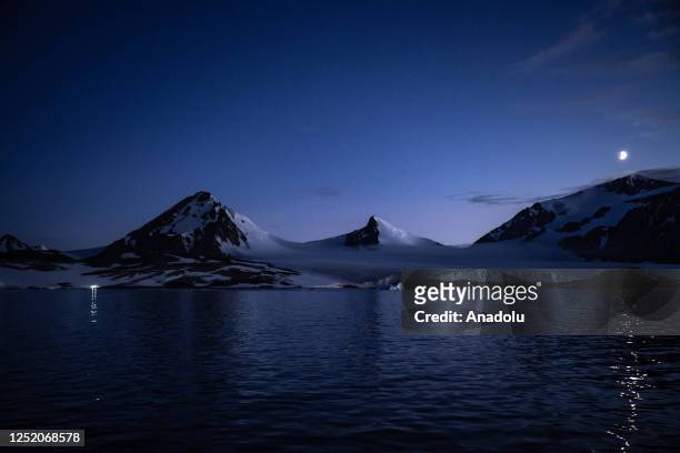 Half moon over snow covered hills during Turkiye's 7th National Antarctic Science Expedition in Antarctica on February 23, 2023. Under the auspices...