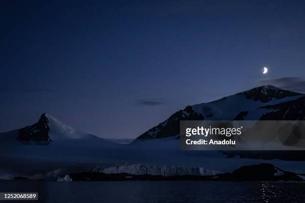 Half moon over snow covered hills during Turkiye's 7th National Antarctic Science Expedition in Antarctica on February 23, 2023. Under the auspices...