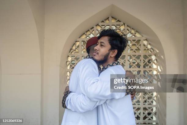 Muslims exchange greetings after performing Eid al-Fitr prayers marking the end of the holy fasting month of Ramadan at at Baitul Mukarram National...